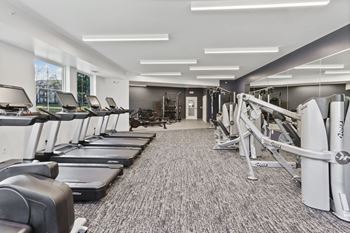 A gym with treadmills and other exercise equipment